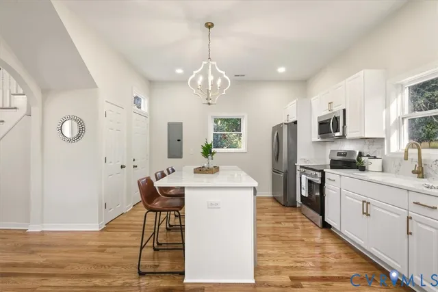a kitchen with stainless steel appliances a refrigerator stove and microwave