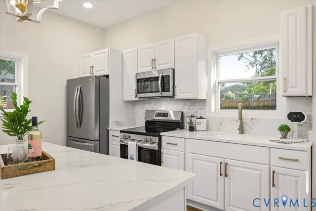 a kitchen with a refrigerator stove and microwave