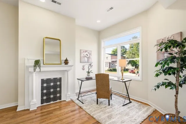 a living room with furniture and a fireplace