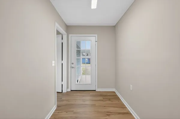 a view of an empty room and wooden floor