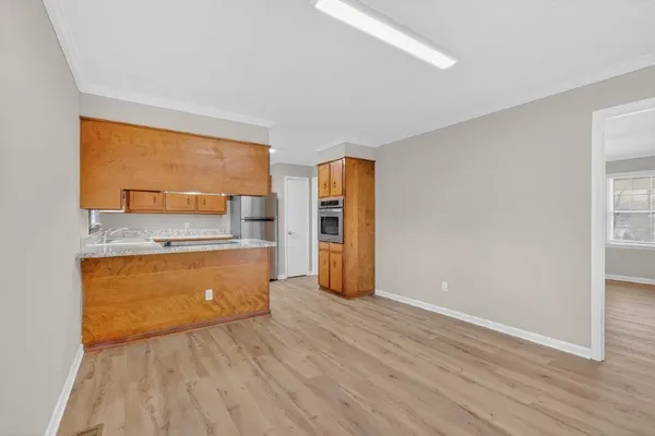 a view of a kitchen with a sink and dishwasher wooden floor