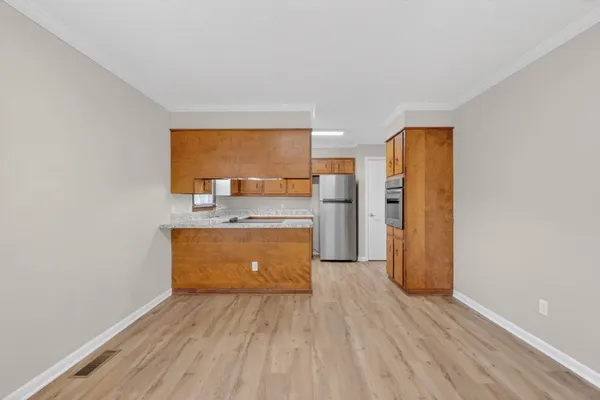 a view of a kitchen with wooden floor