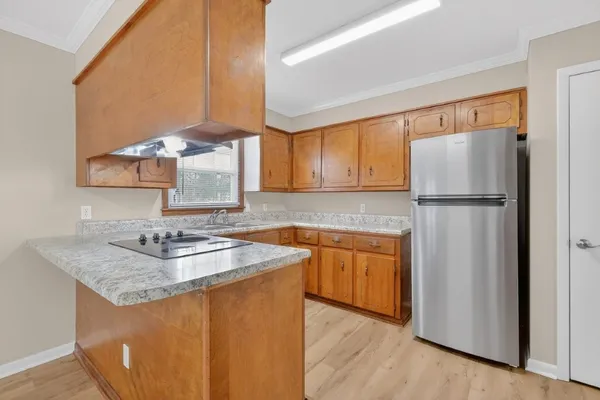 a kitchen with stainless steel appliances granite countertop a refrigerator sink and cabinets