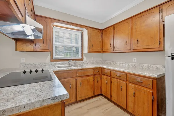 a kitchen with a sink cabinets and window