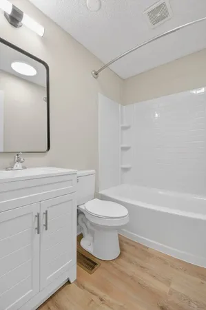 a bathroom with a sink a toilet and a bathtub