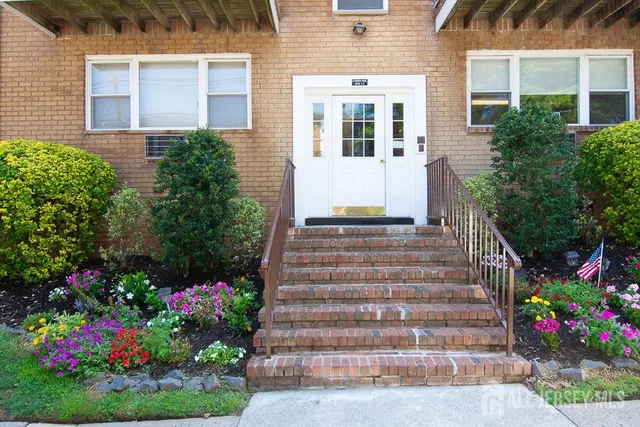 a front view of building with flowers