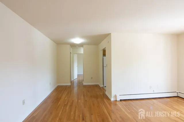 a view of a room with wooden floor
