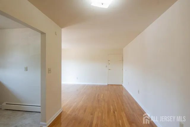 a view of a room with wooden floor