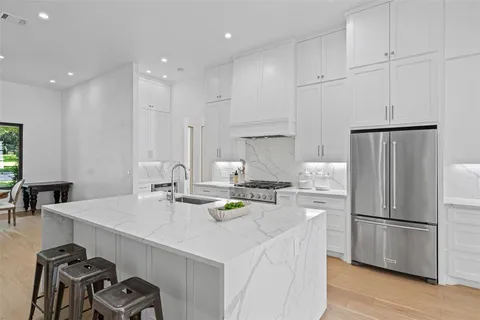 a kitchen with refrigerator and stove