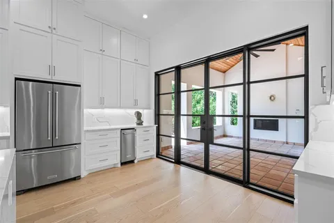 a kitchen with stainless steel appliances granite countertop a refrigerator and a sink