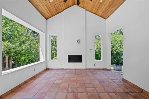 a view of a porch with wooden floor and a yard