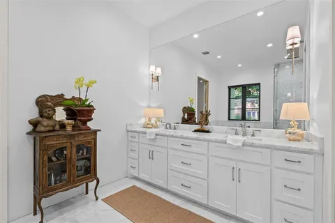a spacious bathroom with a sink and a mirror
