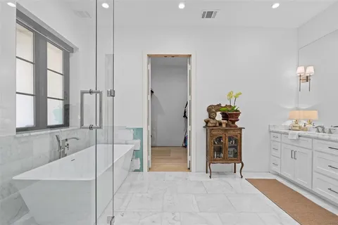 a spacious bathroom with a tub and a sink