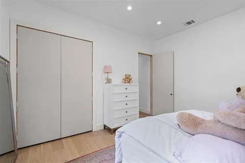 a bedroom with a bed and a dresser