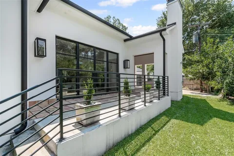 a view of a porch with a floor to ceiling window and yard