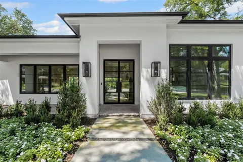 front view of a house with potted plants