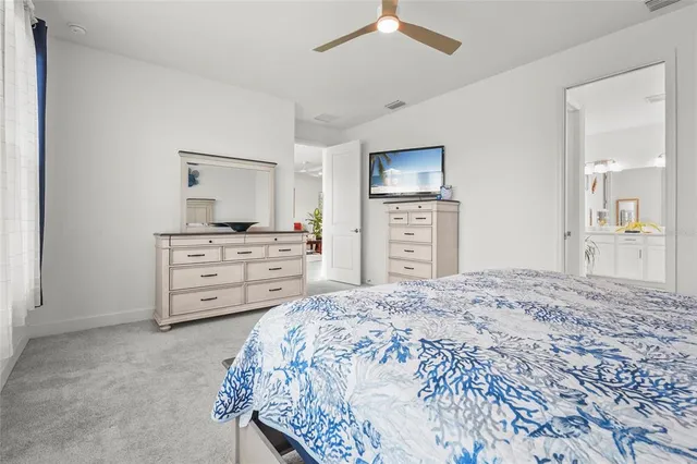 a bedroom with a bed and a dresser