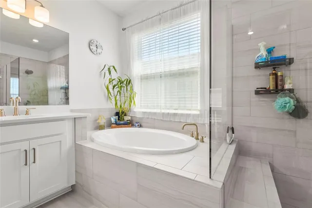 a living room with fireplace furniture and a large window