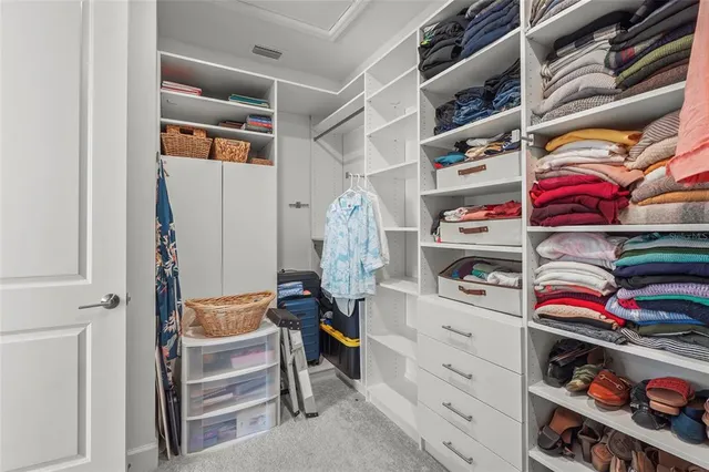 a view of a city with lawn chairs and large trees