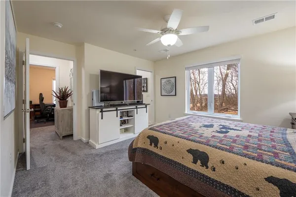 a bedroom with a bed and a flat screen tv