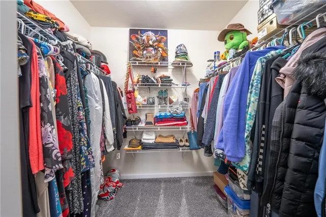 a view of walk in closet with clothes