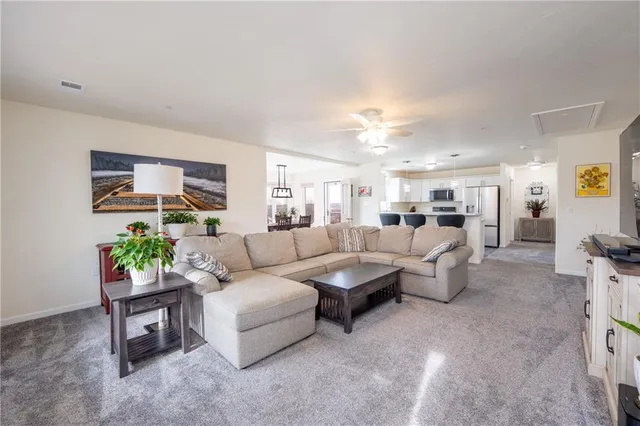 a living room with furniture and a potted plant