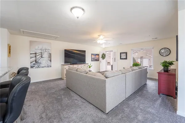 a living room with furniture and flat screen tv