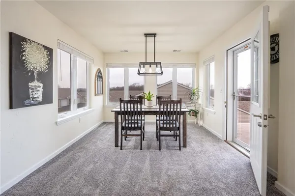 a dining room with furniture and window