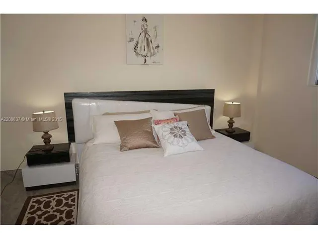 a bedroom with a bed and a lamp