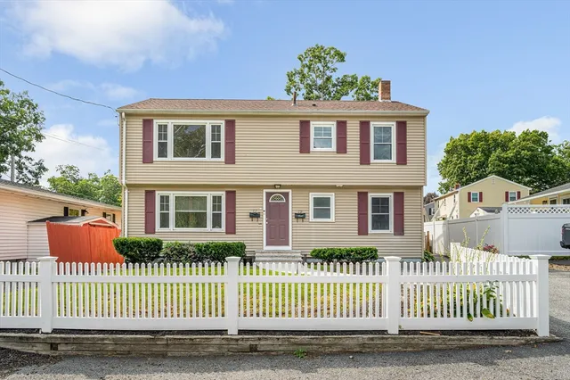 a front view of a house with a fence