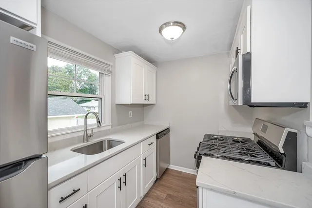 a kitchen with a sink stove and cabinets