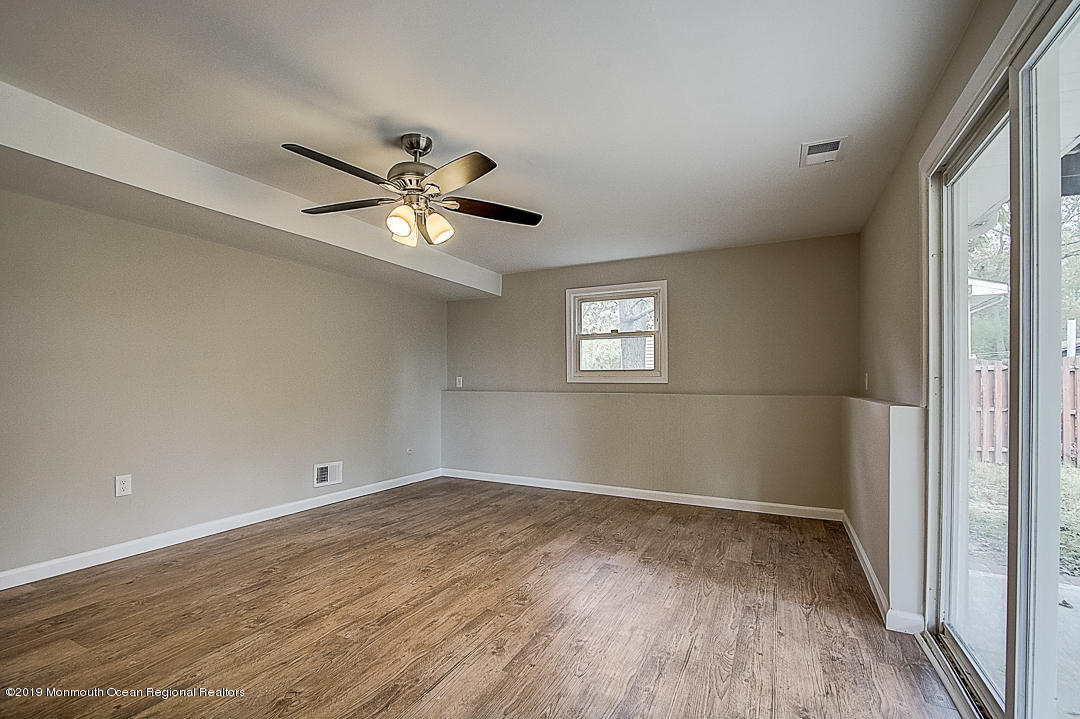 24 Pine Road Howell, NJ 07731 - Photo 18 of 21 wooden floor in an empty room with a window