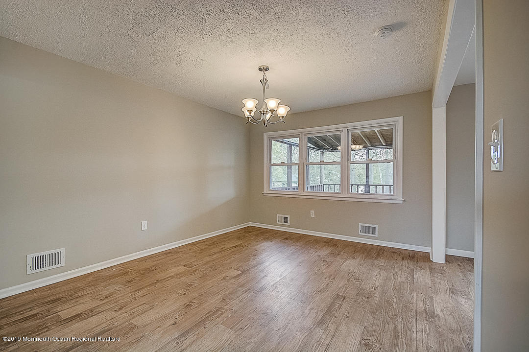 24 Pine Road Howell, NJ 07731 - Photo 4 of 21 wooden floor in an empty room with a window