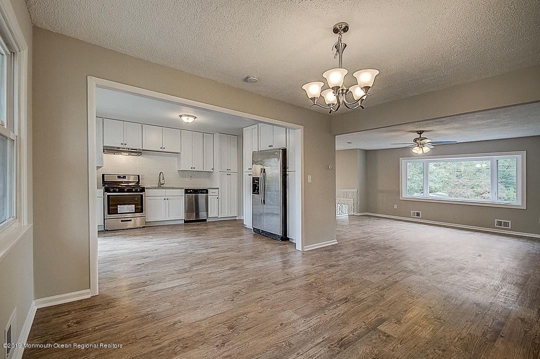 24 Pine Road Howell, NJ 07731 - Photo 5 of 21 a view of a kitchen with a sink and a chandelier
