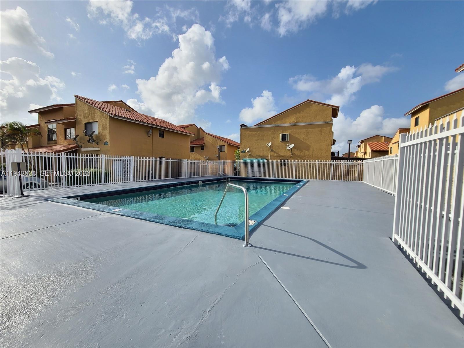 2710 West 60th Place, Unit 202 Hialeah, FL 33016 - Photo 2 of 11 a view of a house with a yard