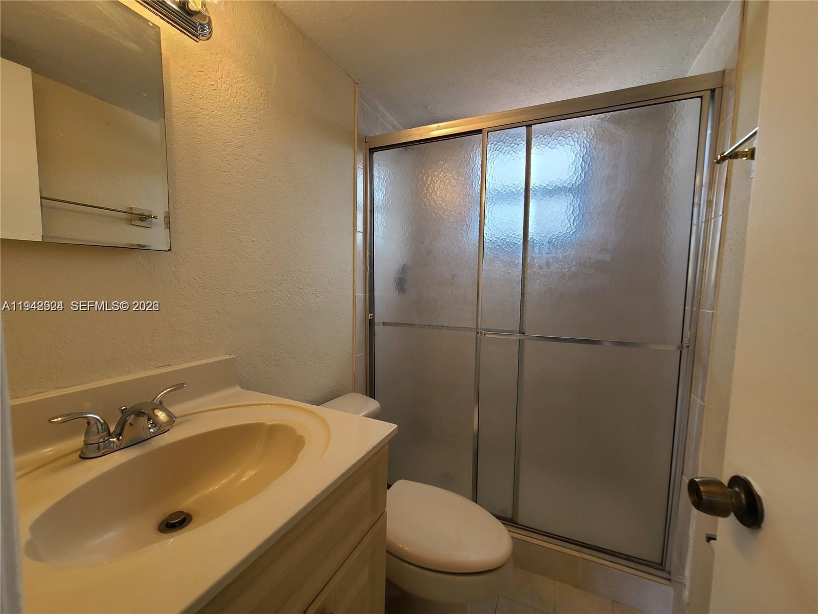 2710 West 60th Place, Unit 202 Hialeah, FL 33016 - Photo 6 of 11 a bathroom with a sink toilet and shower