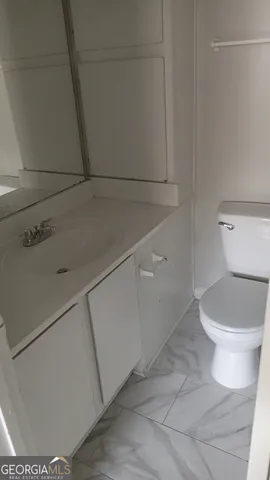 a white toilet sitting next to a shower