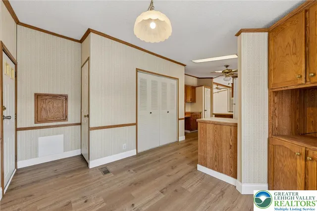 a view of a kitchen with wooden floor and electronic appliances