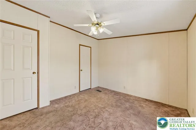 a view of a room with a ceiling fan