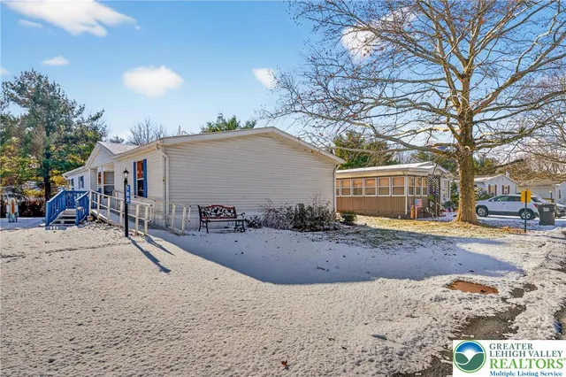 a view of a house with snow on the road