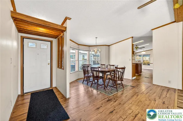 a dining room with furniture window and wooden floor