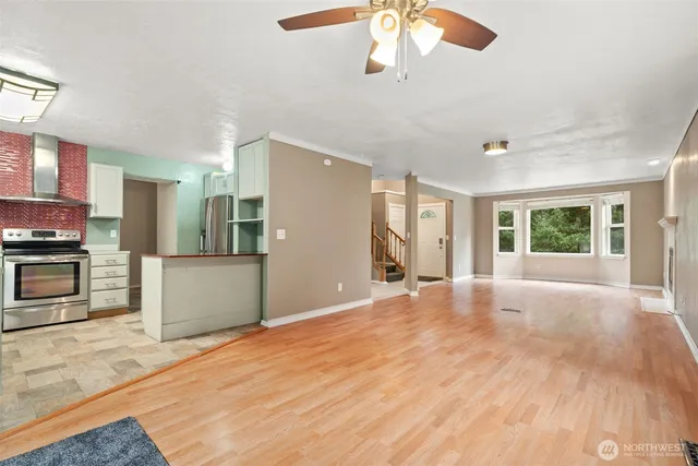 a view of an empty room with a kitchen