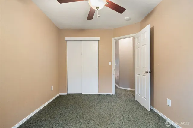 an empty room with a empty space and a ceiling fan