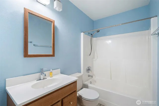 a bathroom with a sink mirror toilet and bathtub