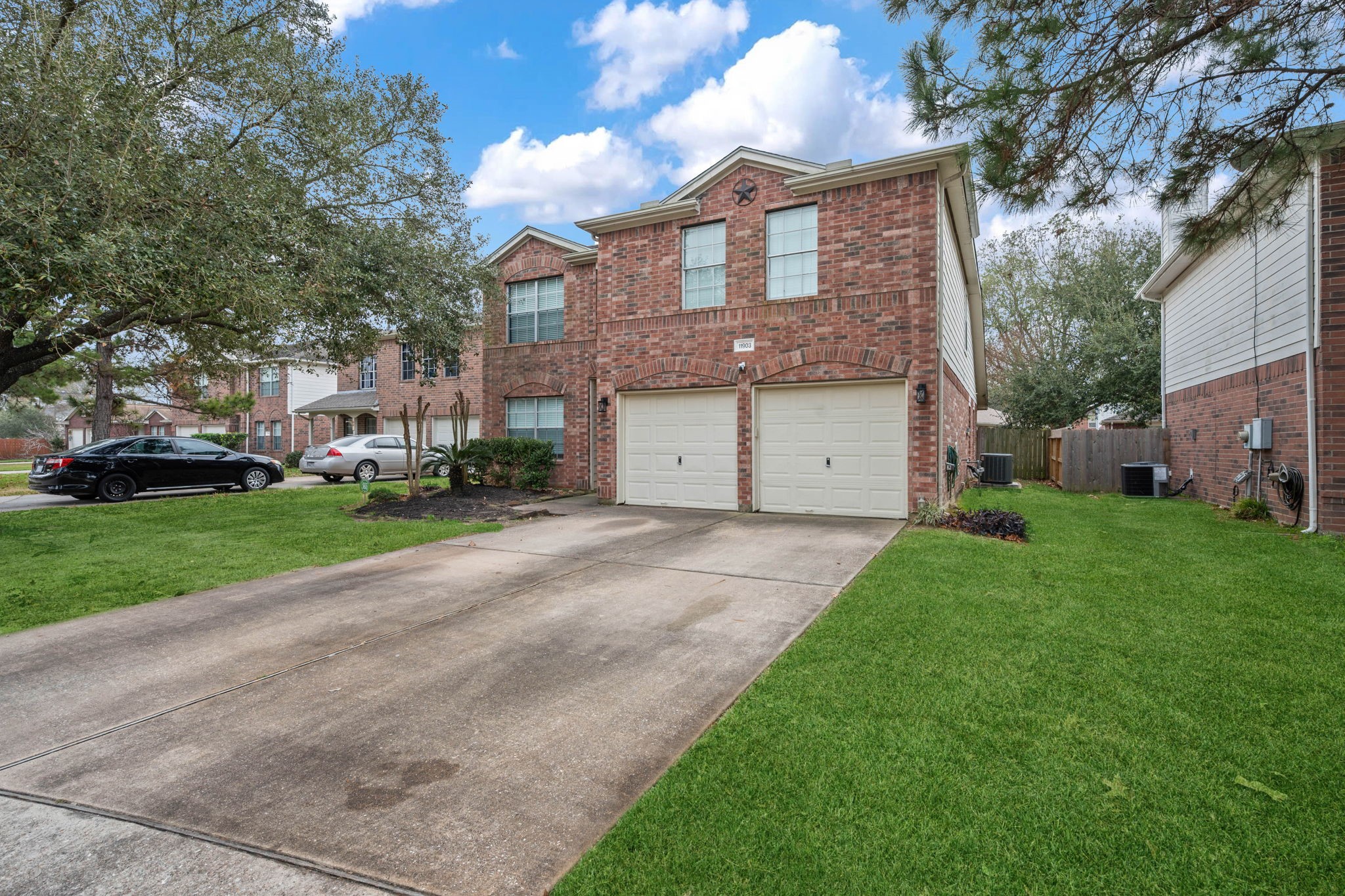 11903 Ezekiel Road Tomball, TX 77375 - Photo 2 of 30 a front view of a house with a garden and trees