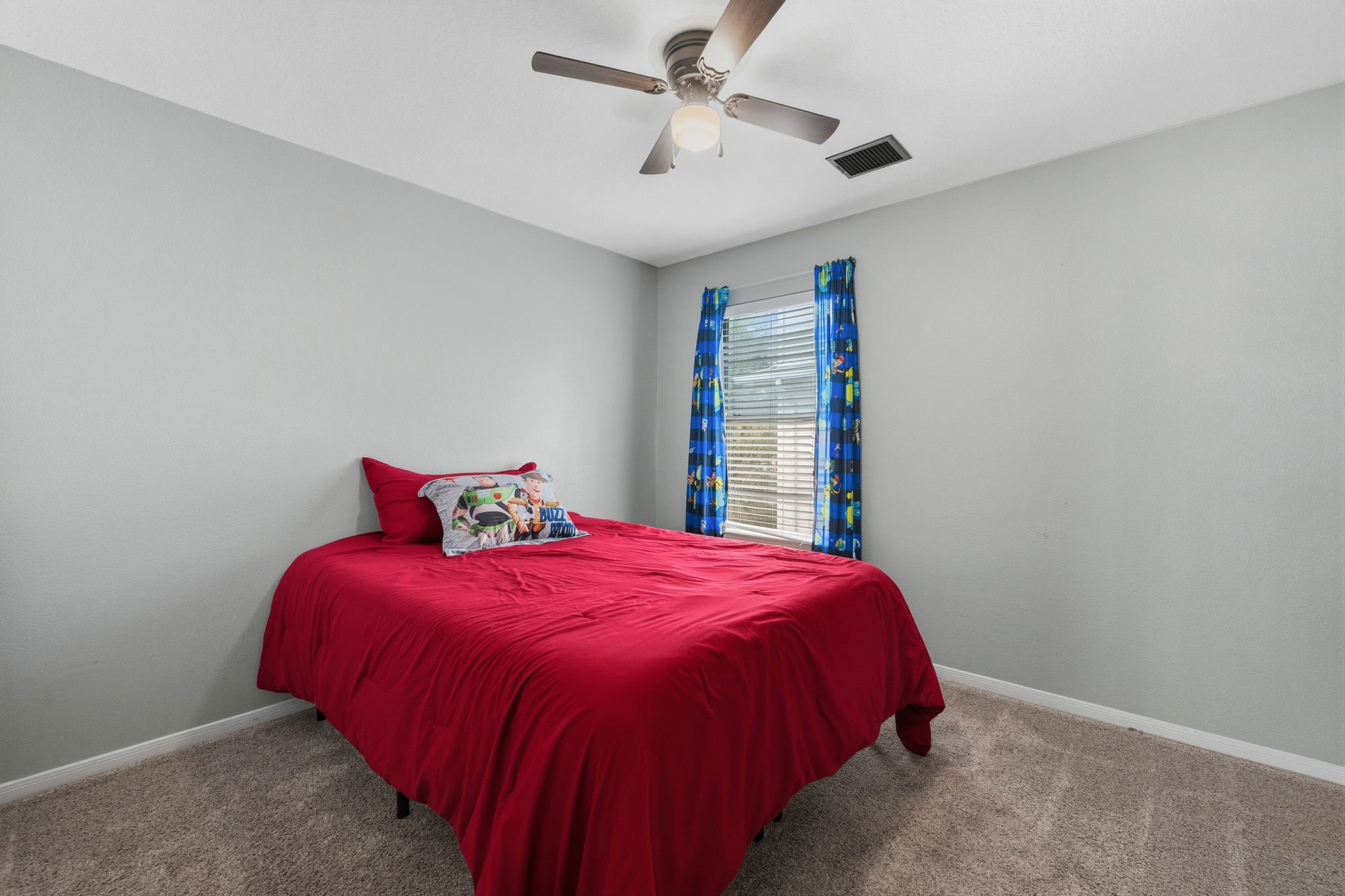 11903 Ezekiel Road Tomball, TX 77375 - Photo 25 of 30 a bedroom with a bed and a chandelier