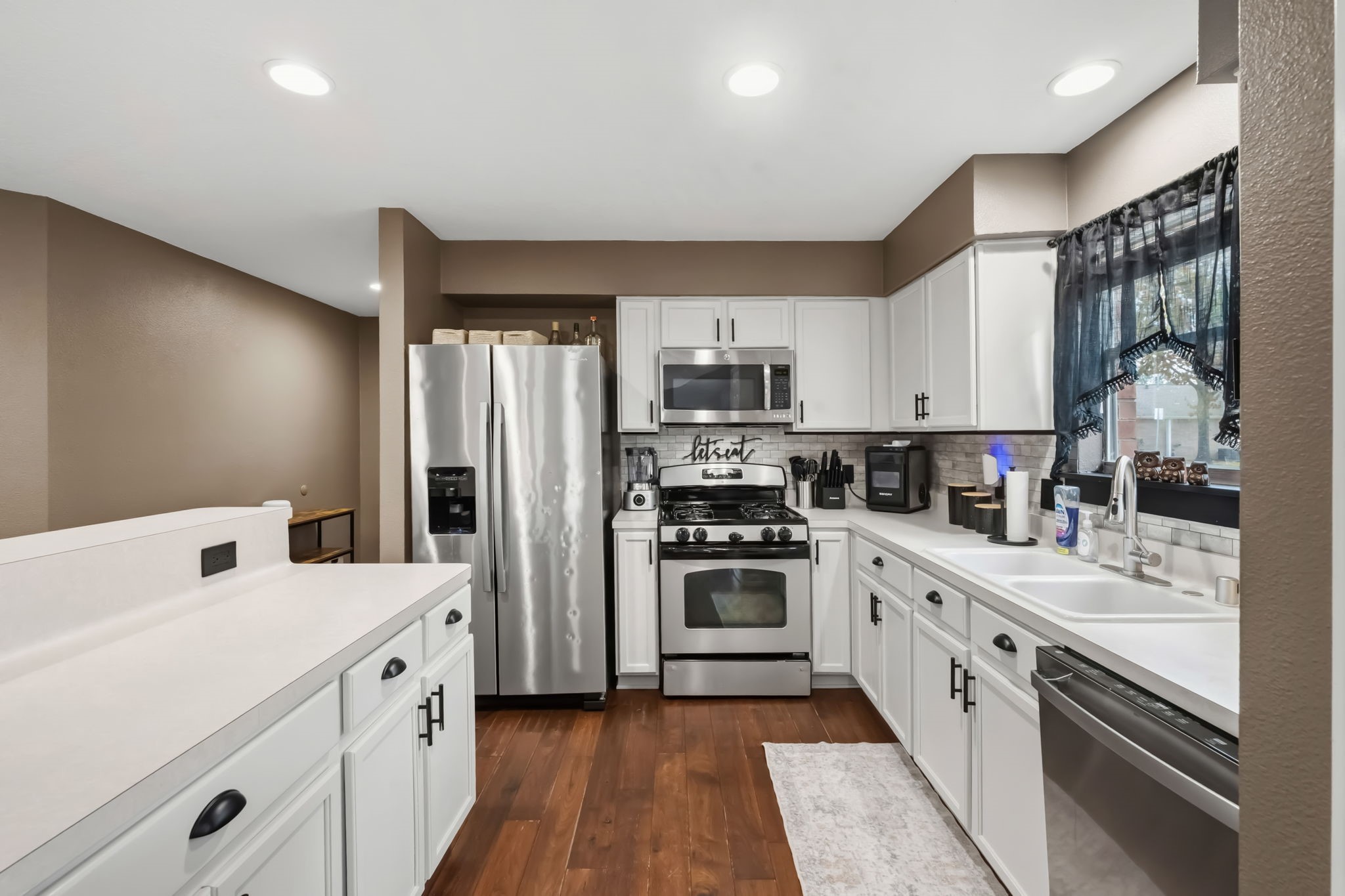 11903 Ezekiel Road Tomball, TX 77375 - Photo 8 of 30 a kitchen with a sink cabinets stainless steel appliances and a window