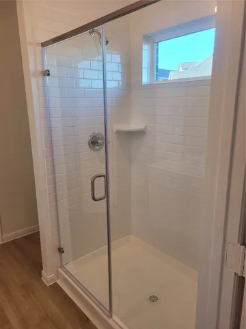 a bathroom with a glass shower door