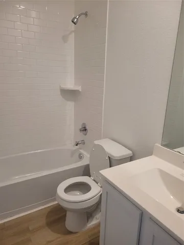 a bathroom with a toilet a sink and bathtub