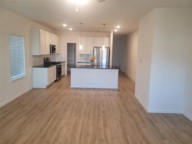 a view of kitchen with cabinets and wooden floor